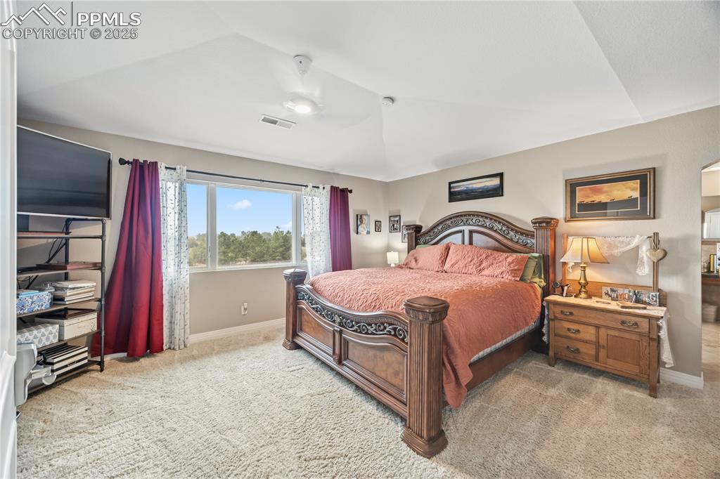 Image 23 of 40: Bedroom with light carpet and ceiling fan