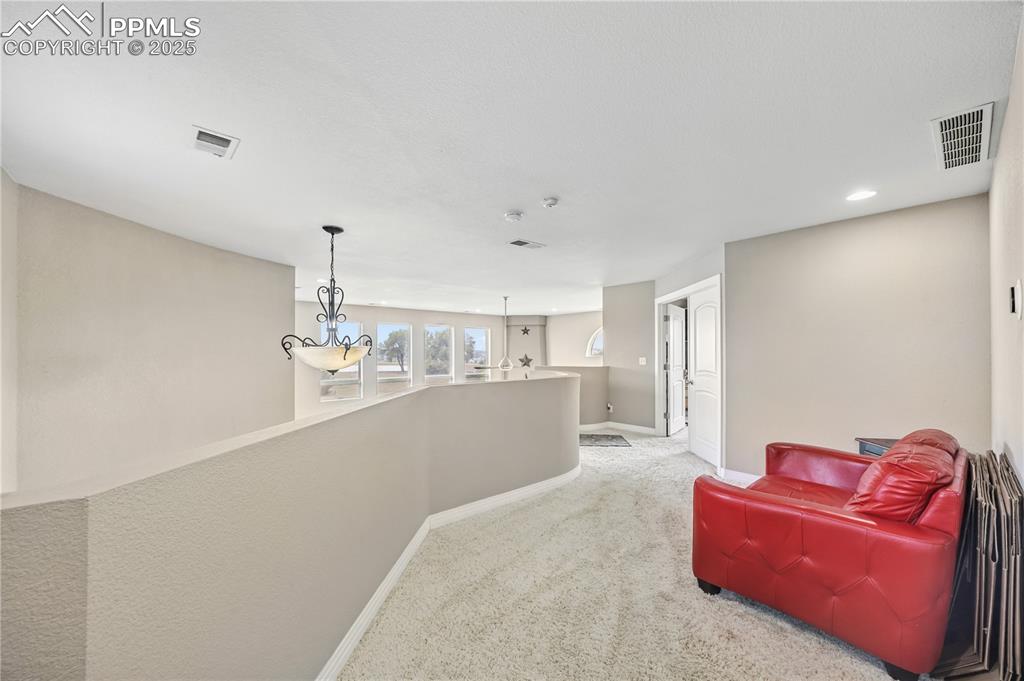 Image 28 of 40: Hallway with carpet floors and recessed lighting