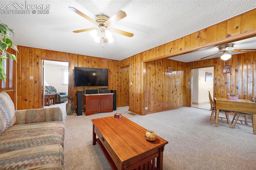 Image 8 of 27: Living room, beautiful knotty pine walls