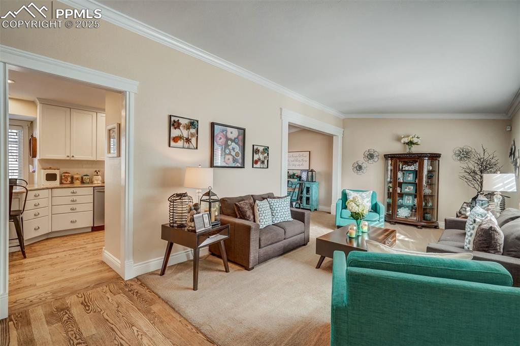 Image 5 of 50: Living room featuring ornamental molding, light wood-style flooring, and ba