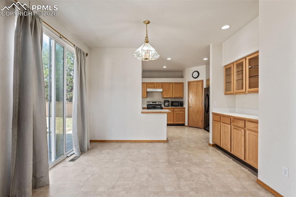 Image 14 of 40: Expansive interior space featuring light-toned flooring, white walls, and w