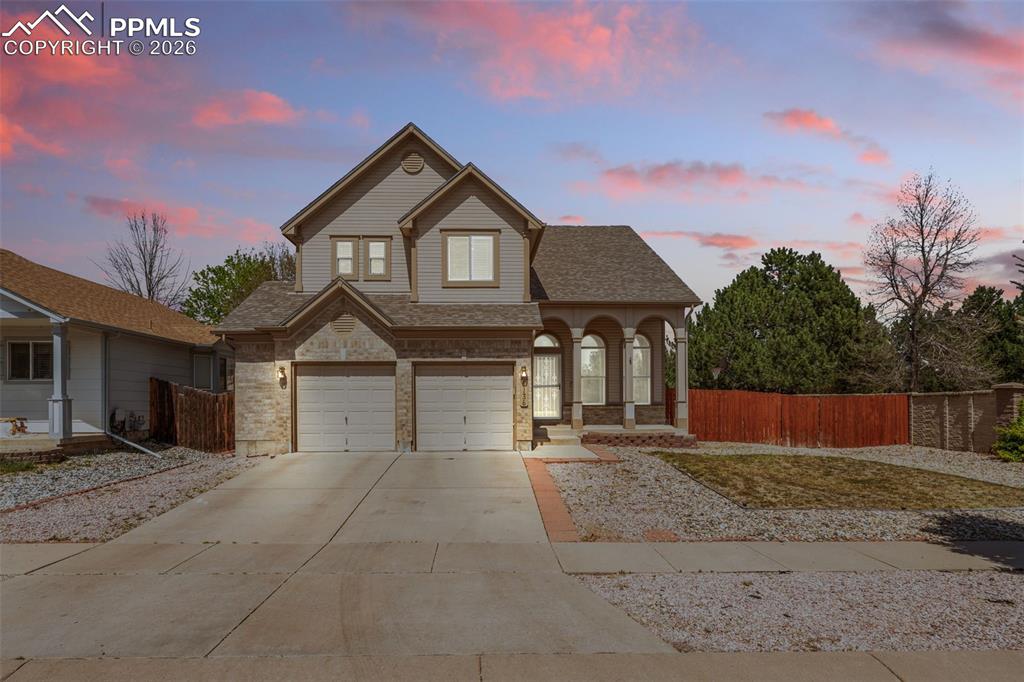 Image 2 of 40: Contemporary two-story residence with a stone and siding facade