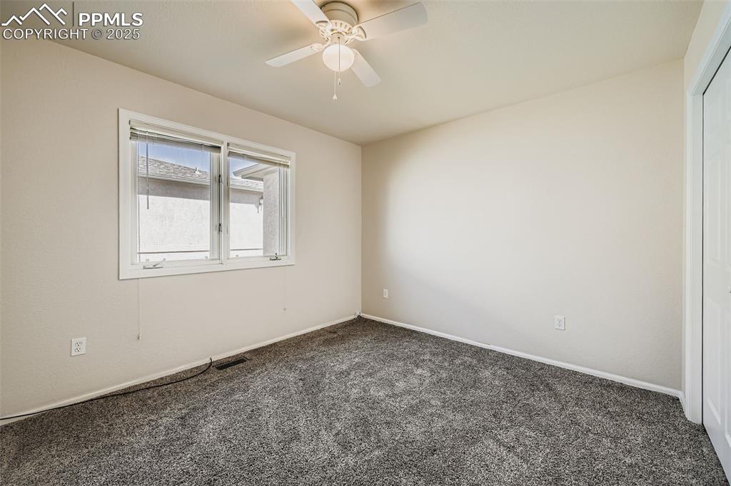 Image 9 of 11: Carpeted spare room with baseboards and ceiling fan