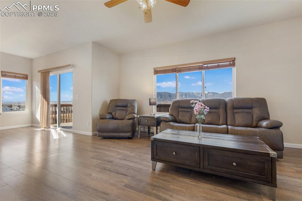Image 12 of 42: Living area featuring wood finished floors and ceiling fan