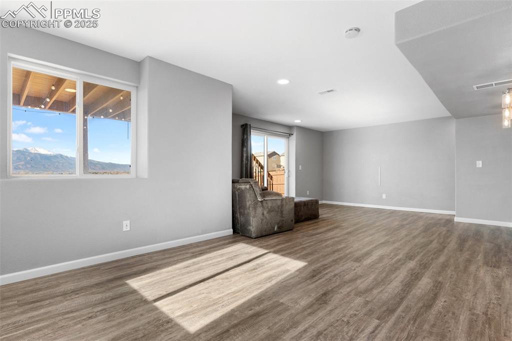 Image 20 of 42: Unfurnished room with baseboards and wood finished floors