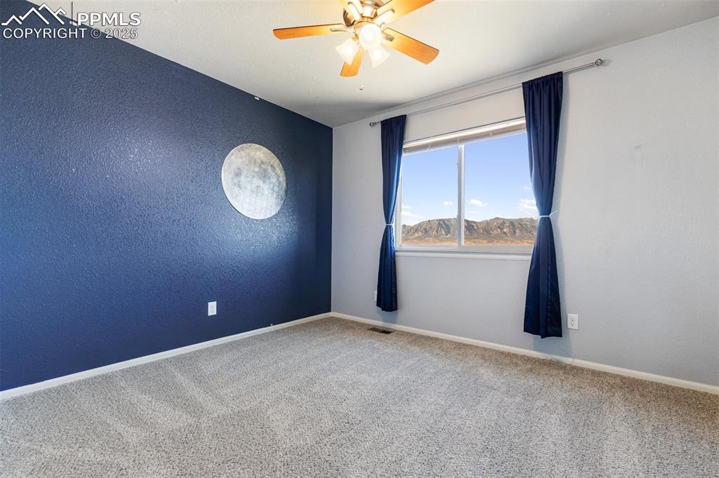 Image 27 of 42: Carpeted empty room featuring ceiling fan and a textured wall