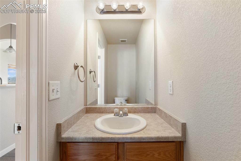 Image 32 of 42: Bathroom featuring vanity and a textured wall
