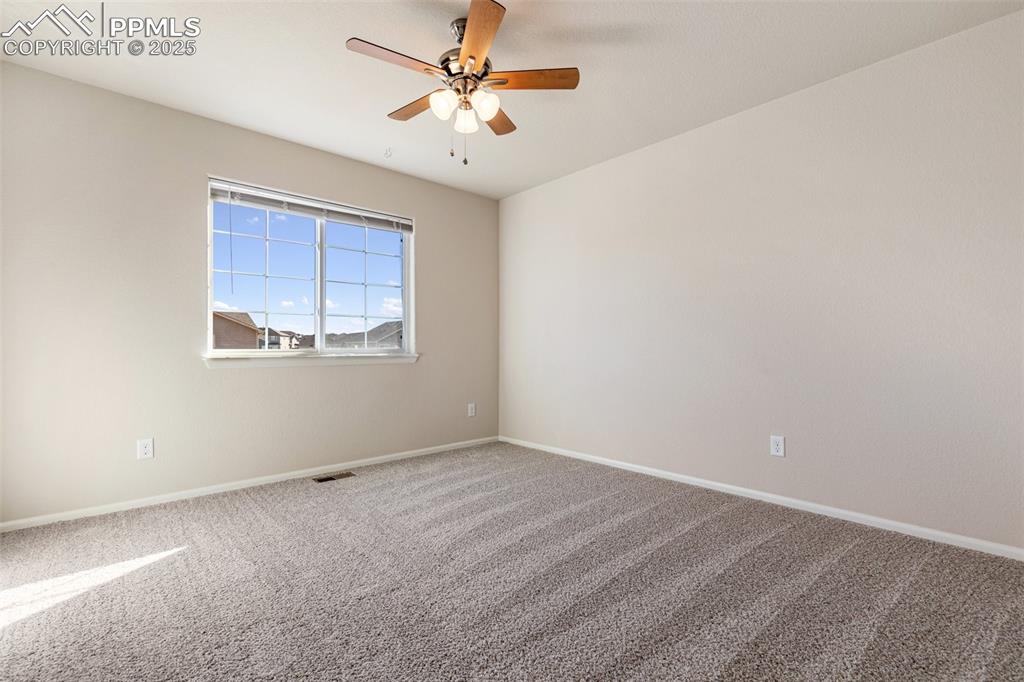 Image 33 of 42: Spare room featuring carpet flooring and a ceiling fan