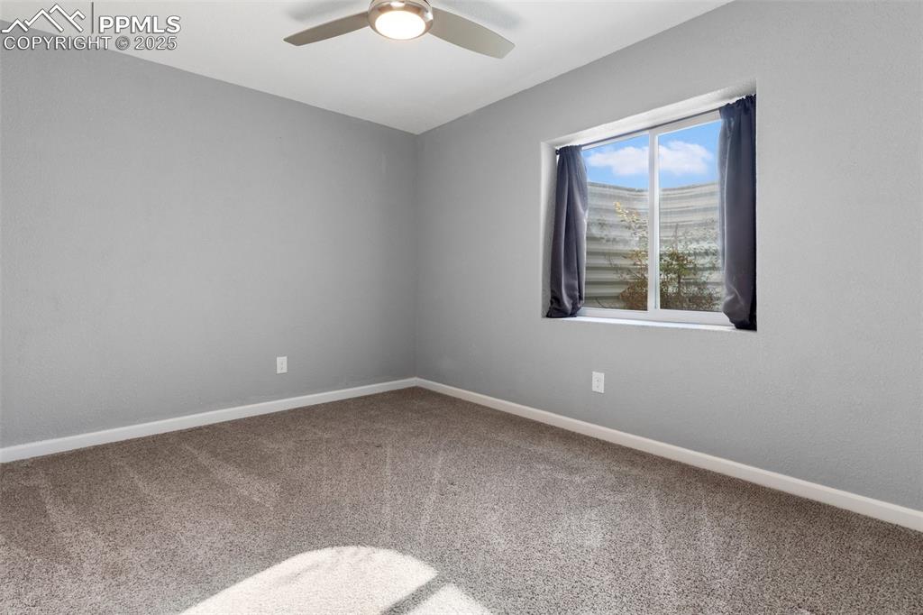 Image 36 of 42: Carpeted empty room featuring baseboards and a ceiling fan