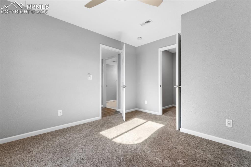 Image 37 of 42: Unfurnished bedroom featuring carpet floors, a textured wall, and ceiling f