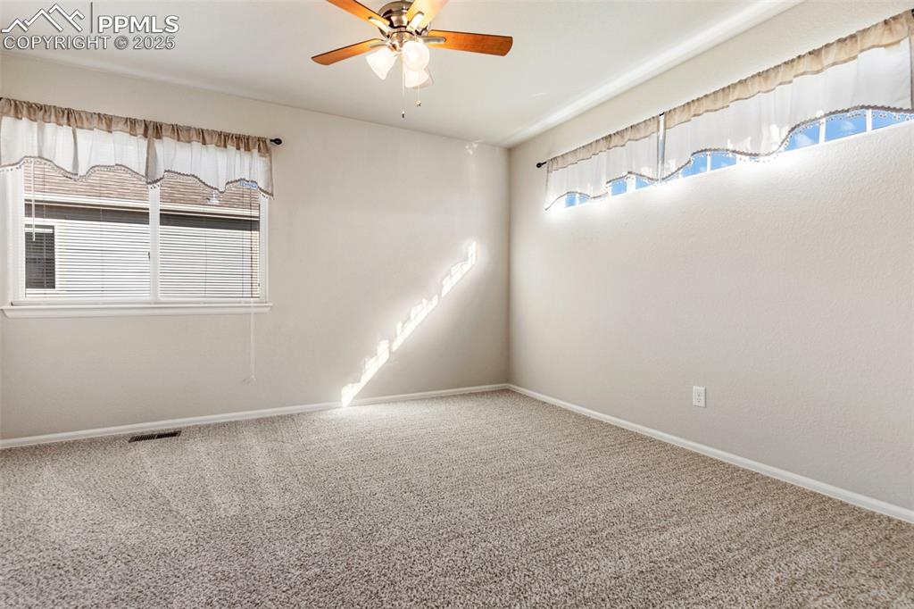 Image 38 of 42: Empty room featuring carpet floors, healthy amount of natural light, and a 