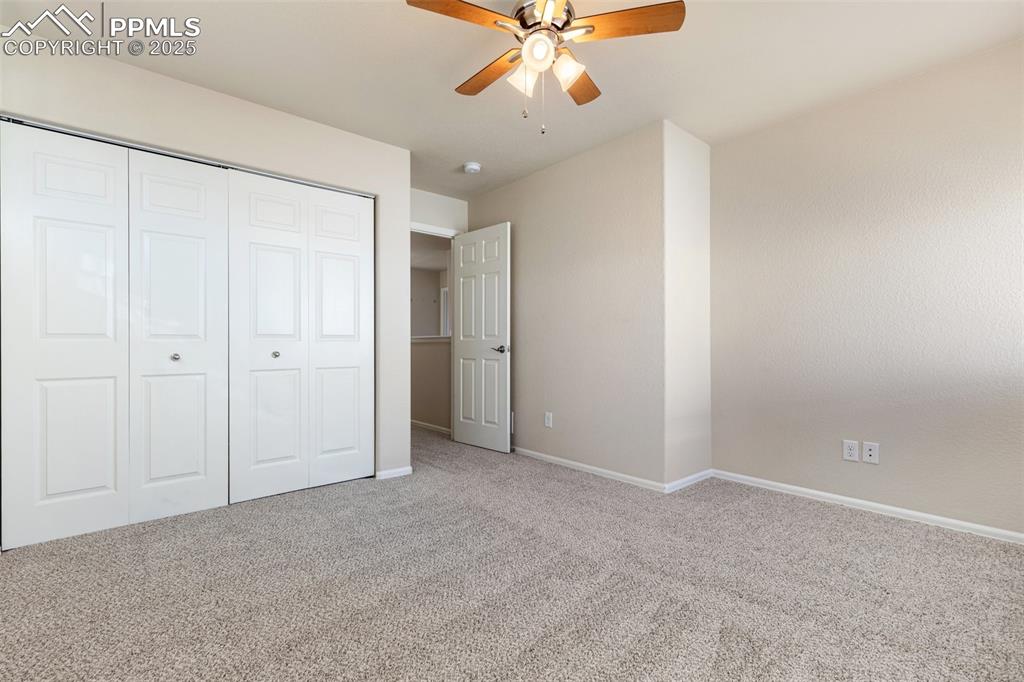 Image 40 of 42: Unfurnished bedroom with carpet floors, a ceiling fan, and a closet