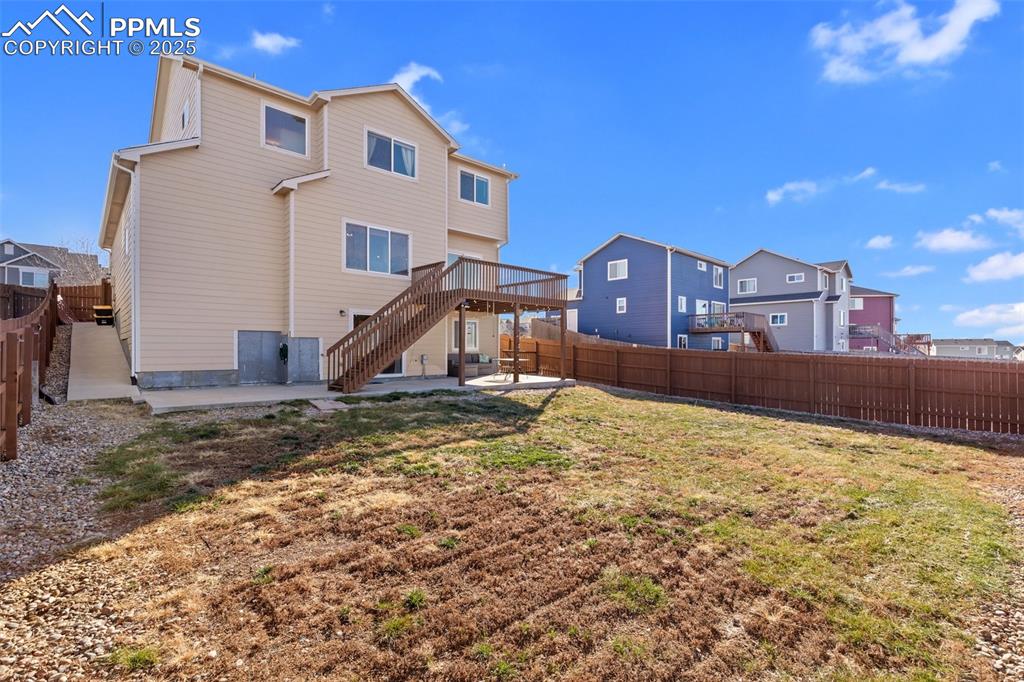 Image 9 of 42: Rear view of house featuring a patio area, a fenced backyard, a deck, and a