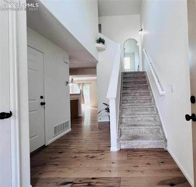 Image 10 of 35: Stairway with wood finished floors and baseboards