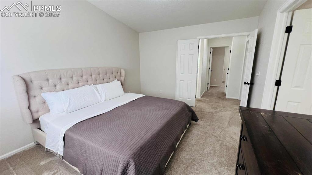 Image 12 of 35: Bedroom featuring light colored carpet