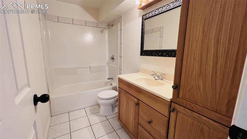 Image 26 of 35: Bathroom featuring vanity, tile patterned flooring, and shower / bath combi