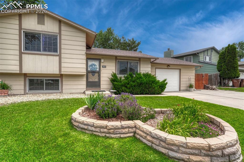 Image 13 of 33: Beautiful front lawn with fabulous flowers about to bloom