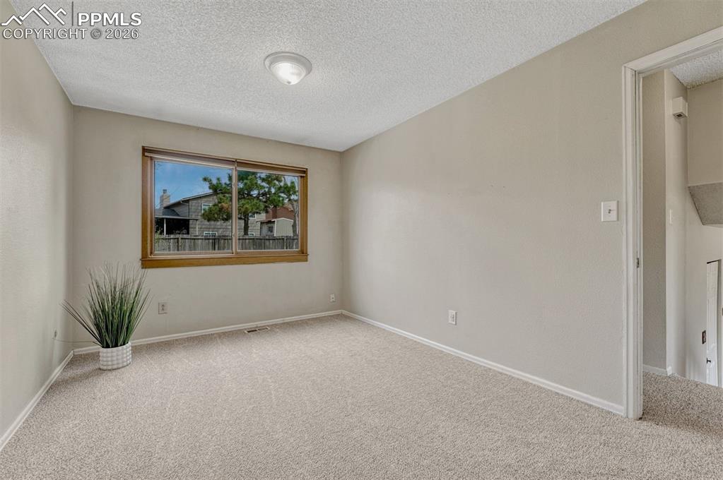 Image 7 of 33: Upper level bedroom 1