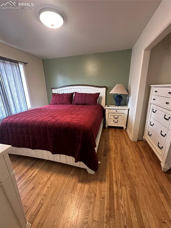 Image 12 of 12: Bedroom with wood-type flooring