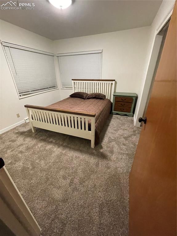 Image 2 of 12: Bedroom with carpet flooring and baseboards