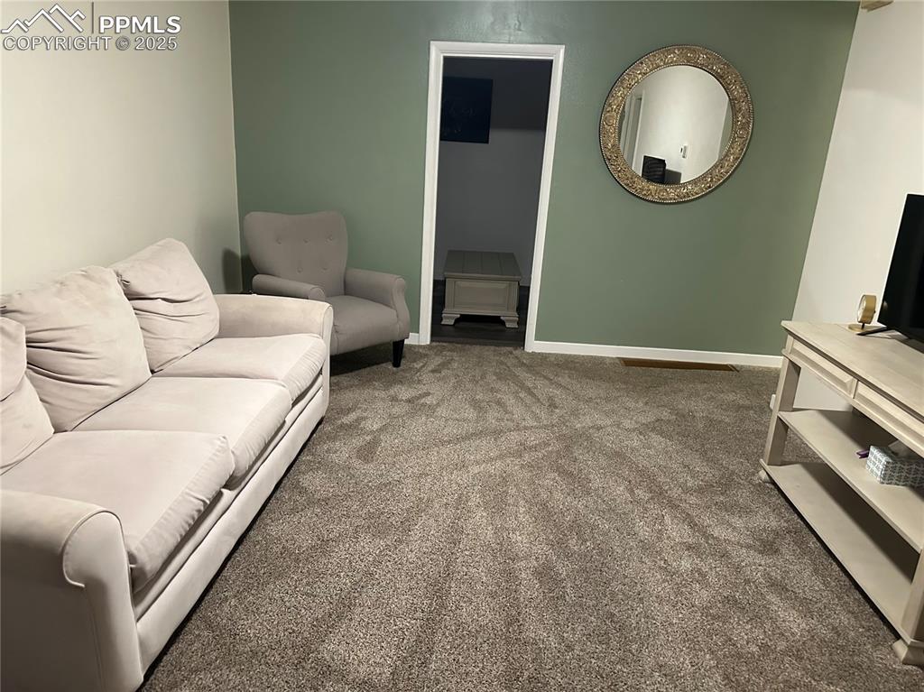 Image 9 of 12: Carpeted living area featuring baseboards