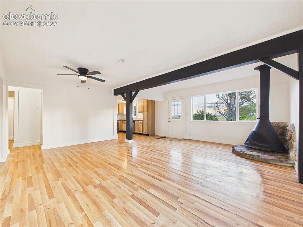 Image 12 of 50: Great Room – Architectural beam details add character to this bright, open