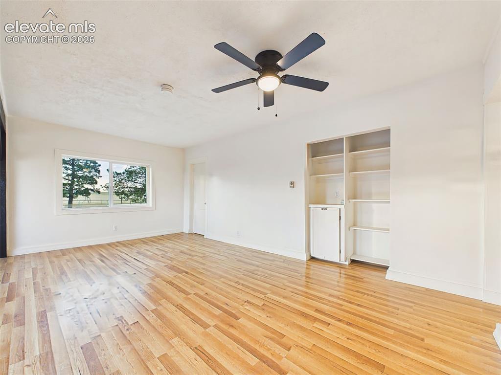 Image 16 of 50: Living Room – Comfortable living area with built-in shelving, oversized win