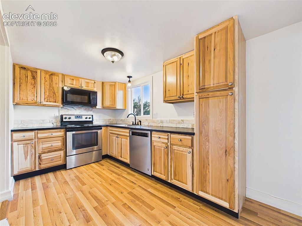 Image 17 of 50: Kitchen – Completely remodeled kitchen featuring custom wood cabinetry, upd