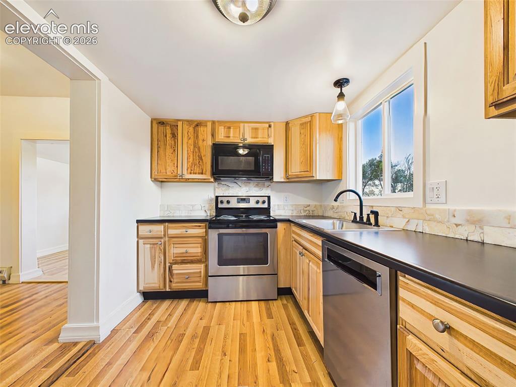 Image 18 of 50: Kitchen – Bright, functional kitchen with ample cabinet storage, stainless