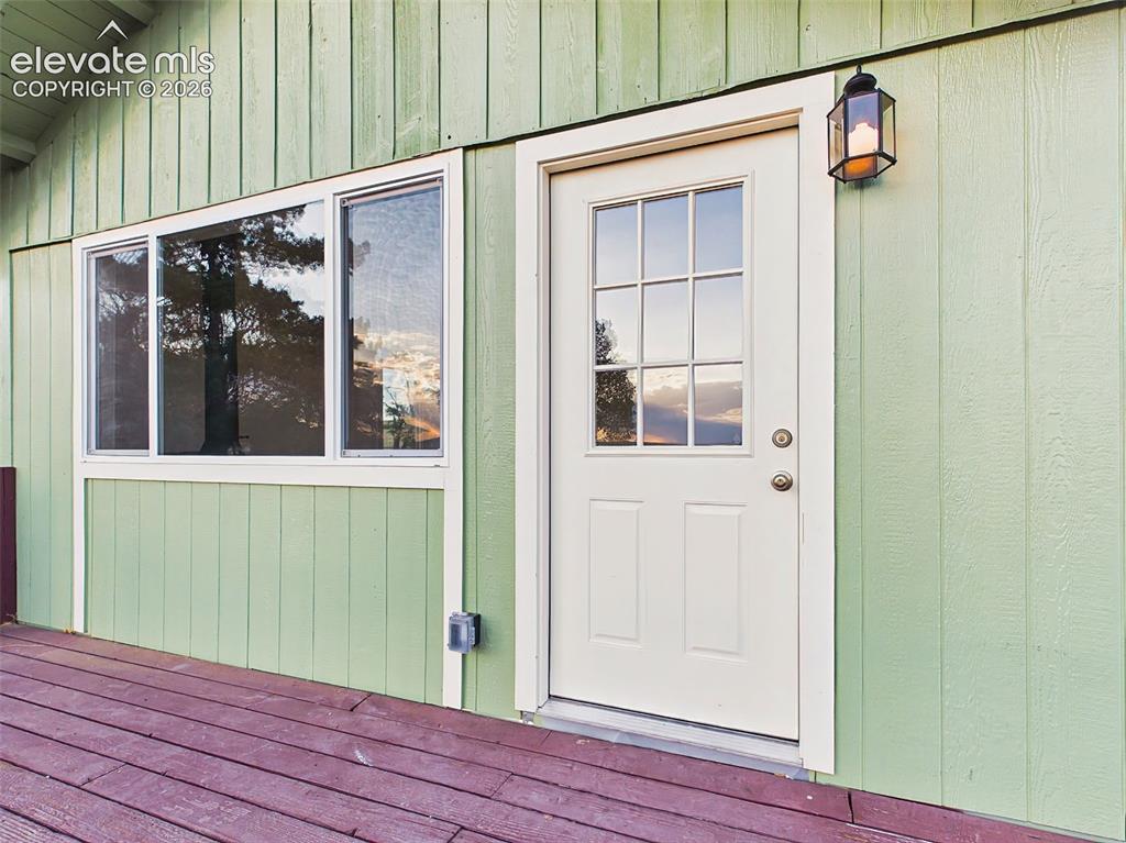 Image 2 of 50: Front Entry & Deck – Freshly updated front entrance with new exterior light