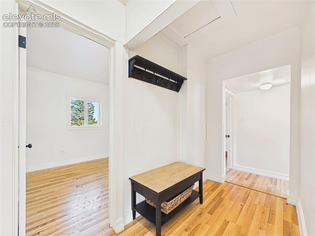 Image 26 of 50: Mudroom/Hallway – Functional entry hallway includes a built-in bench and co