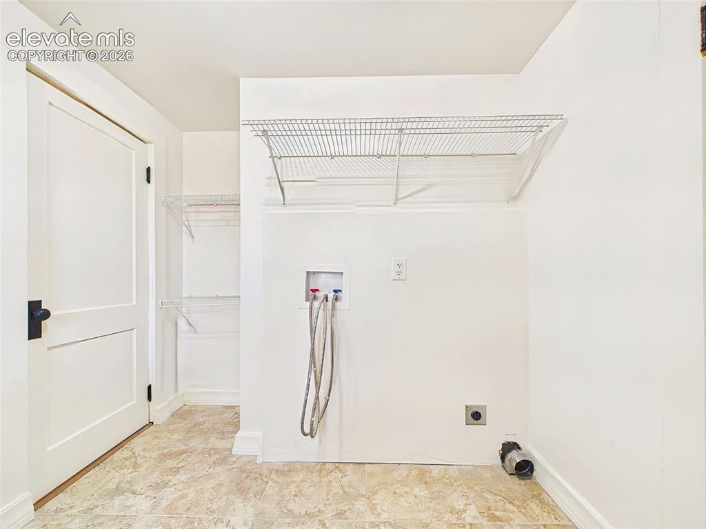 Image 36 of 50: Laundry Area – Laundry area is thoughtfully integrated into the full bathro