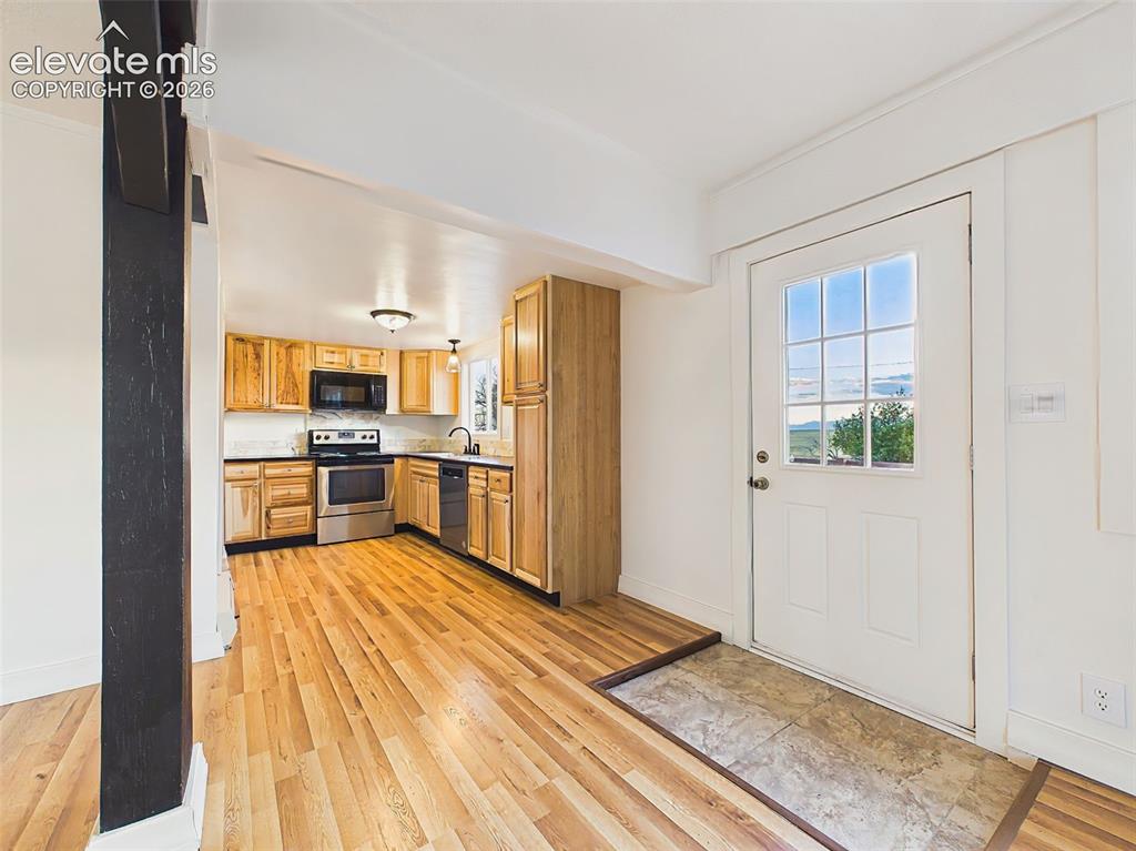 Image 4 of 50: Entryway – Welcoming tiled entryway opens to the spacious living room and k
