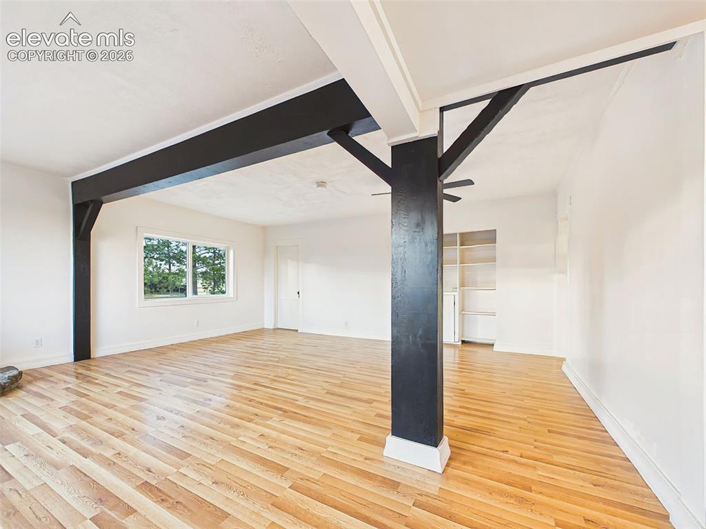 Image 6 of 50: Great Room – Architectural beam details add character to this bright, open