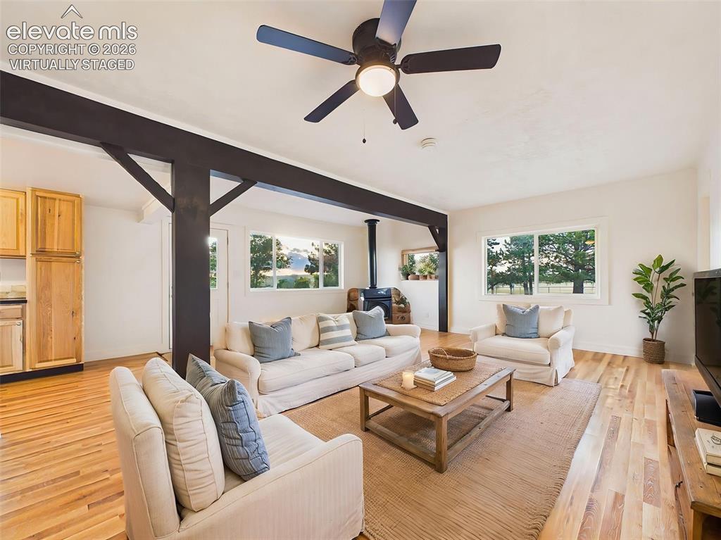 Image 7 of 50: (Virtually Staged) Great Room – Spacious great room featuring exposed beams