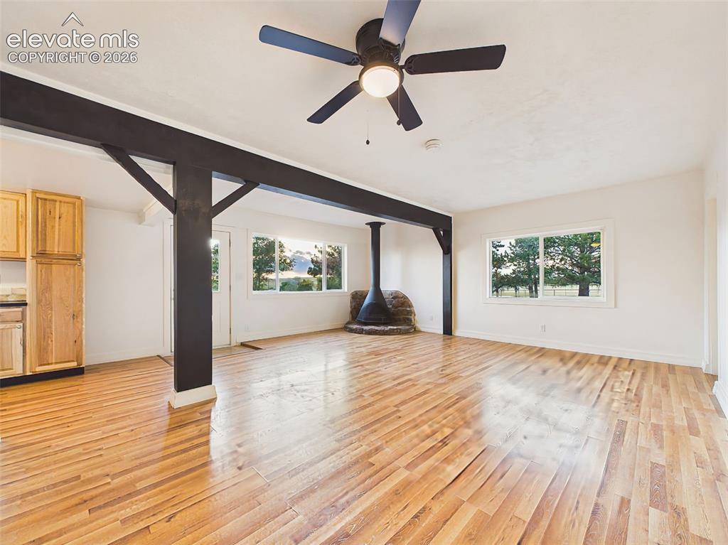 Image 8 of 50: Great Room – Spacious open-concept great room, exposed beams, updated lamin