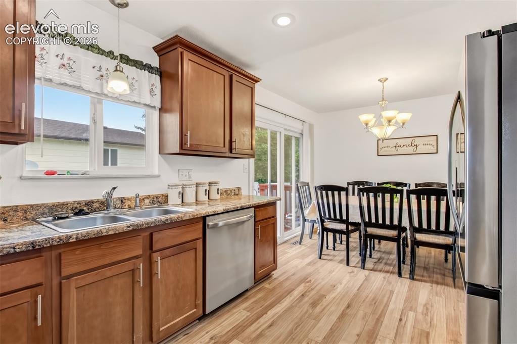Image 4 of 18: Eat in Kitchen with wood flooring and stainless steel appliances