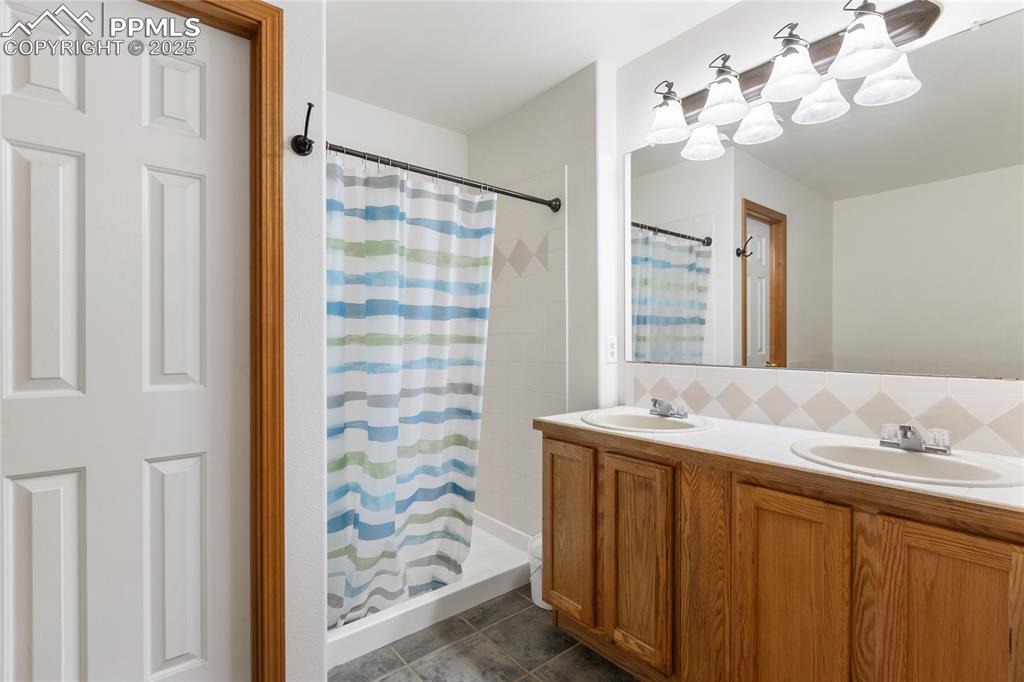 Image 11 of 28: 5 piece primary bathroom with a stall shower, double vanity, tasteful backs