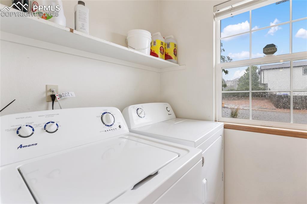 Image 21 of 28: Laundry area with washing machine and dryer