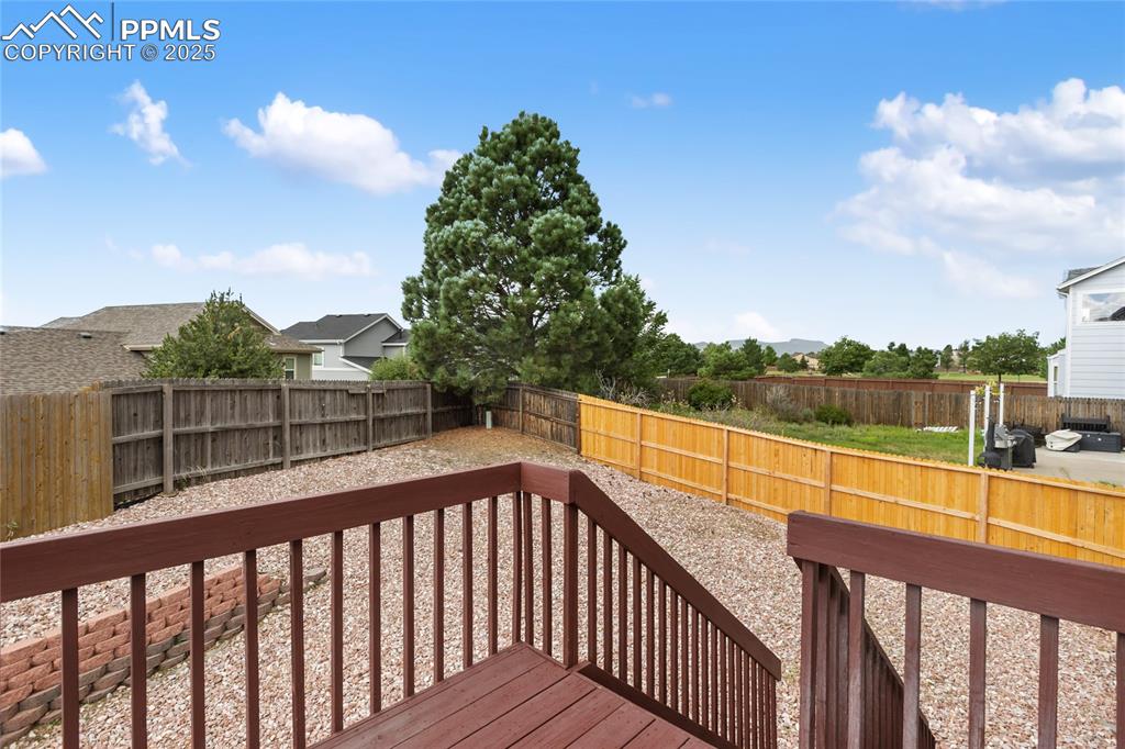 Image 23 of 28: Wooden deck with view of the mountains. It is better in person!