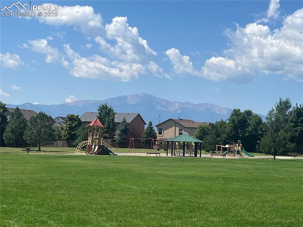 Image 26 of 28: View of community park featuring a playground and a mountain view