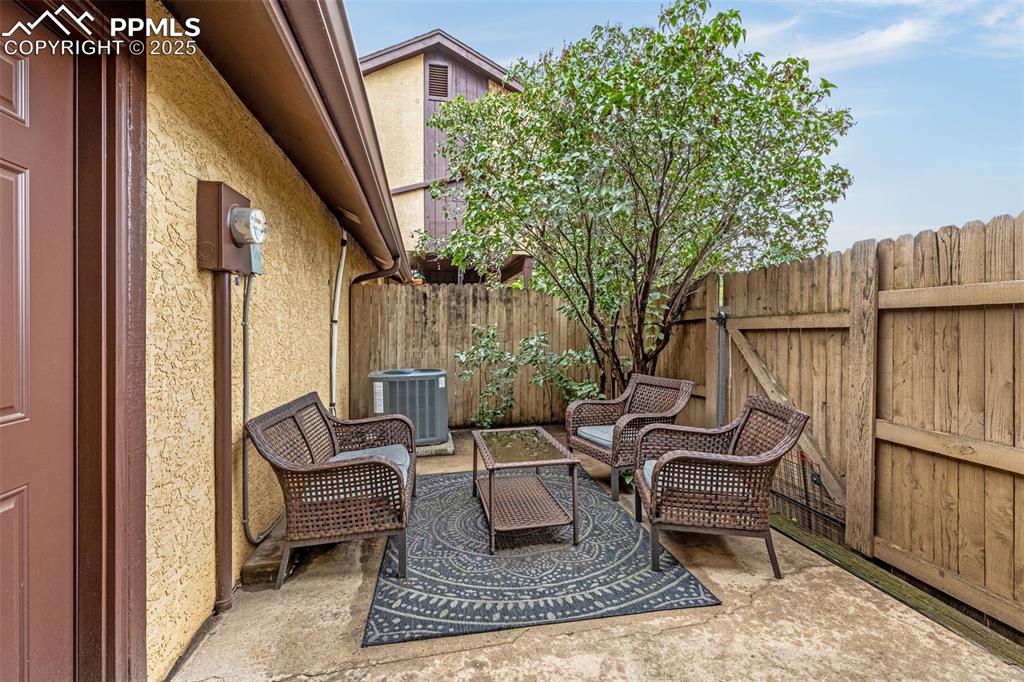 Image 10 of 19: Patio off of kitchen with access to garage. Fenced and private!