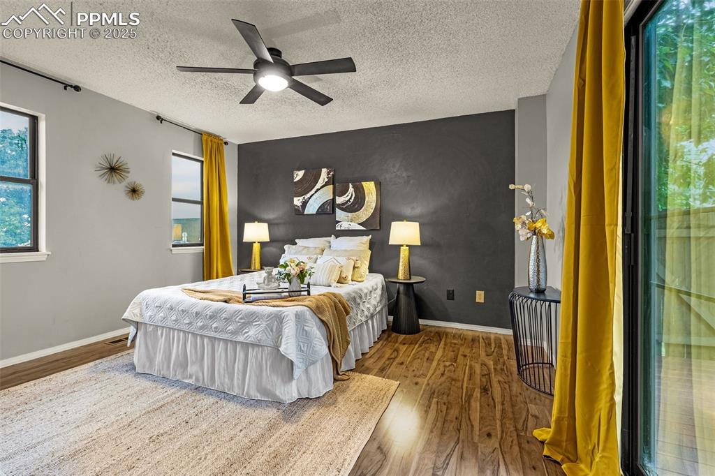 Image 11 of 19: Primary bedroom is on the main floor with modern accent wall