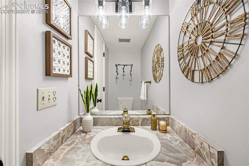 Image 15 of 19: Half bath on main floor