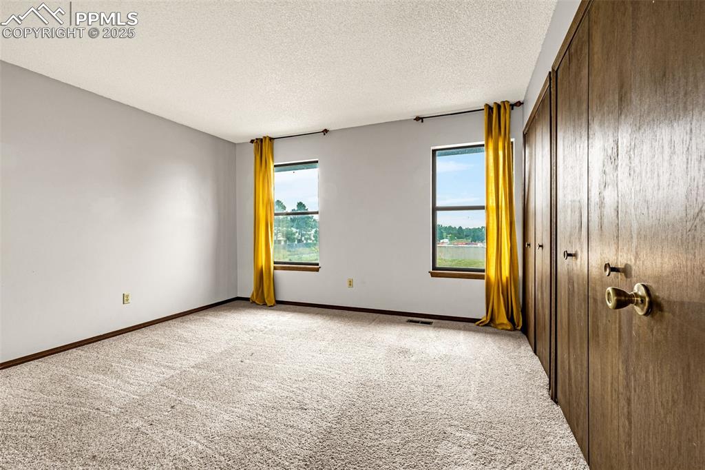Image 16 of 19: Bedroom 1 upstairs with double closets
