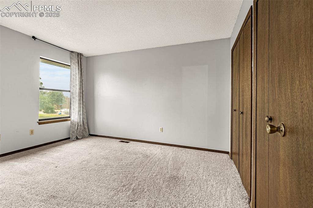 Image 18 of 19: Bedroom 3 upstairs with double closets