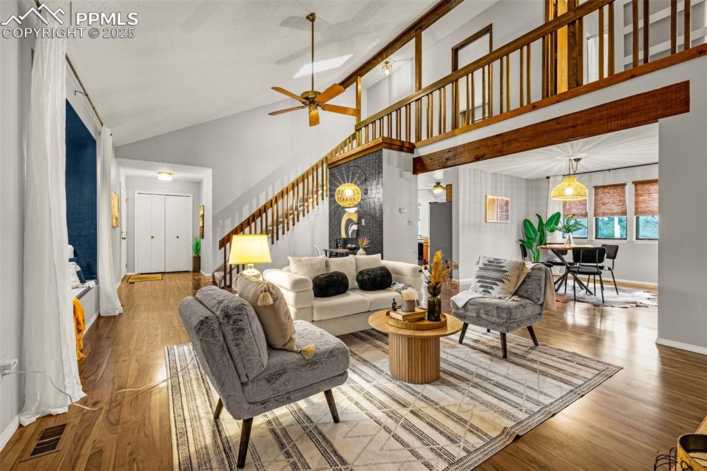 Image 4 of 19: Living room with skylight; open to formal dining room and upper floor