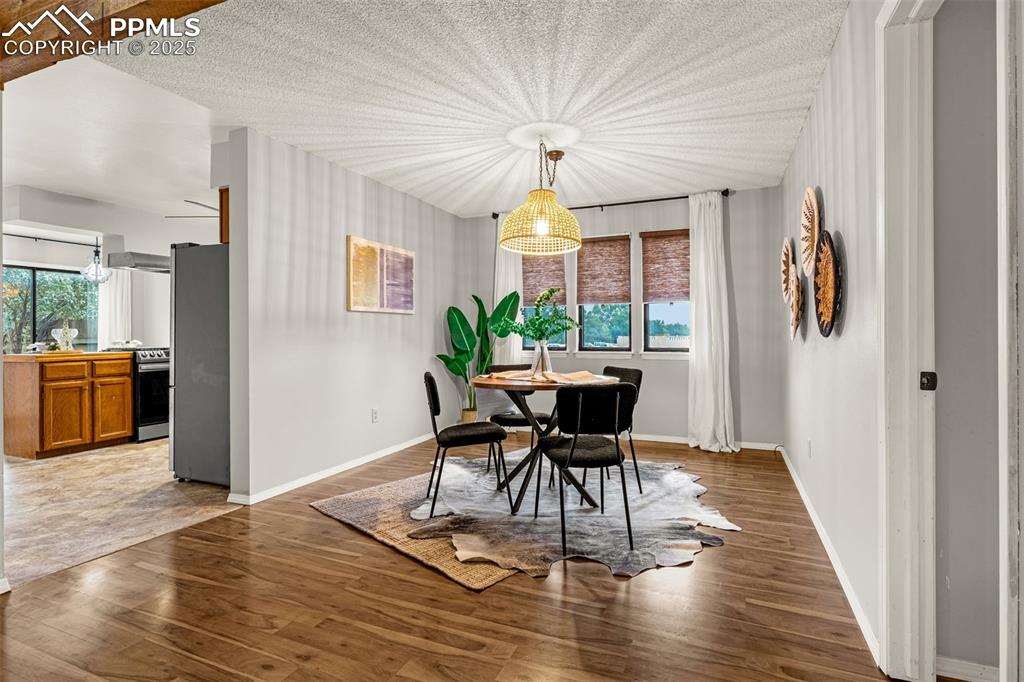 Image 6 of 19: Retro vibe light fixture brings character to the formal dining room