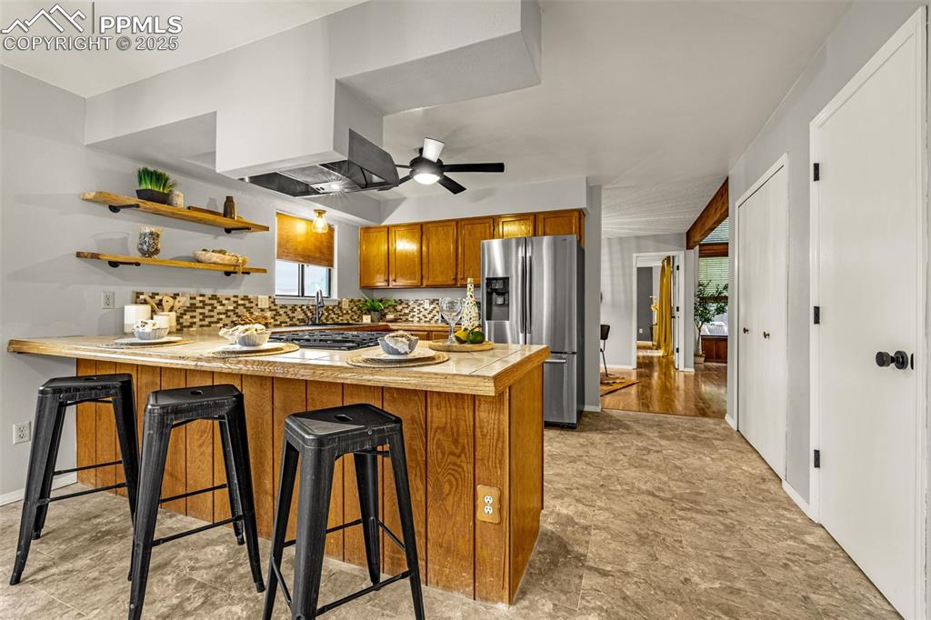 Image 8 of 19: Breakfast bar, pantry and laundry closet easily accessible