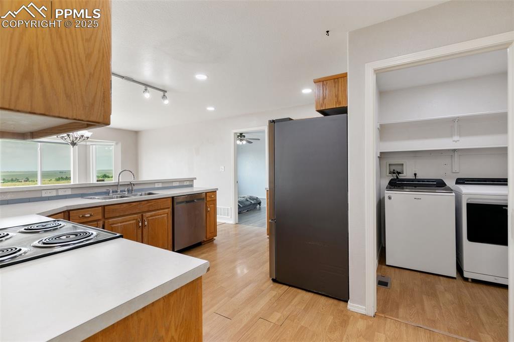 Image 16 of 50: Main Floor Laundry Room is right off the kitchen and leads to the attached